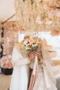 Couple celebrating an Asian wedding at Wilton Hall, Milton Keynes
